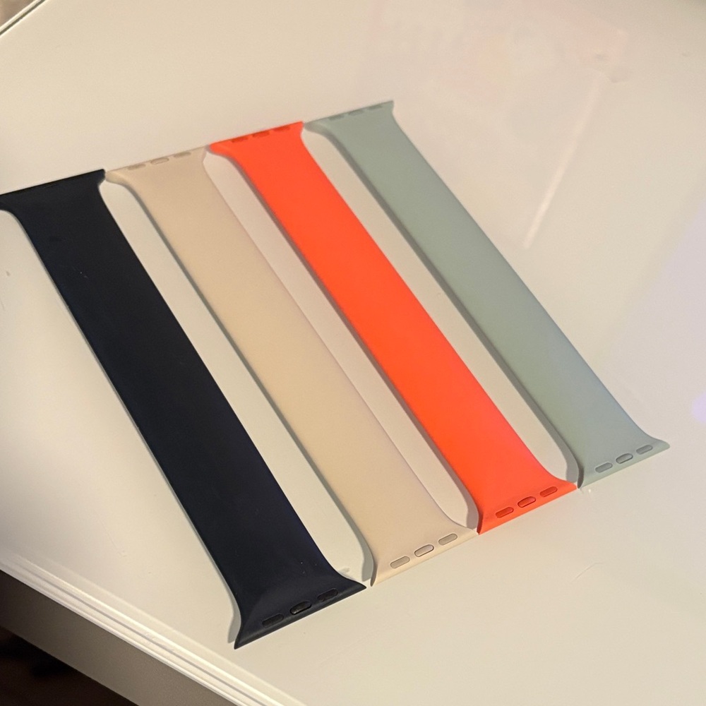 Apple Watch solo bands in  Navy, Beige, Orange, and Sage